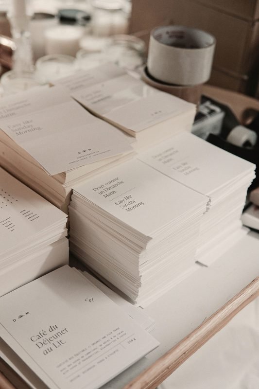 Stacks of printed cards and small paper goods on a table