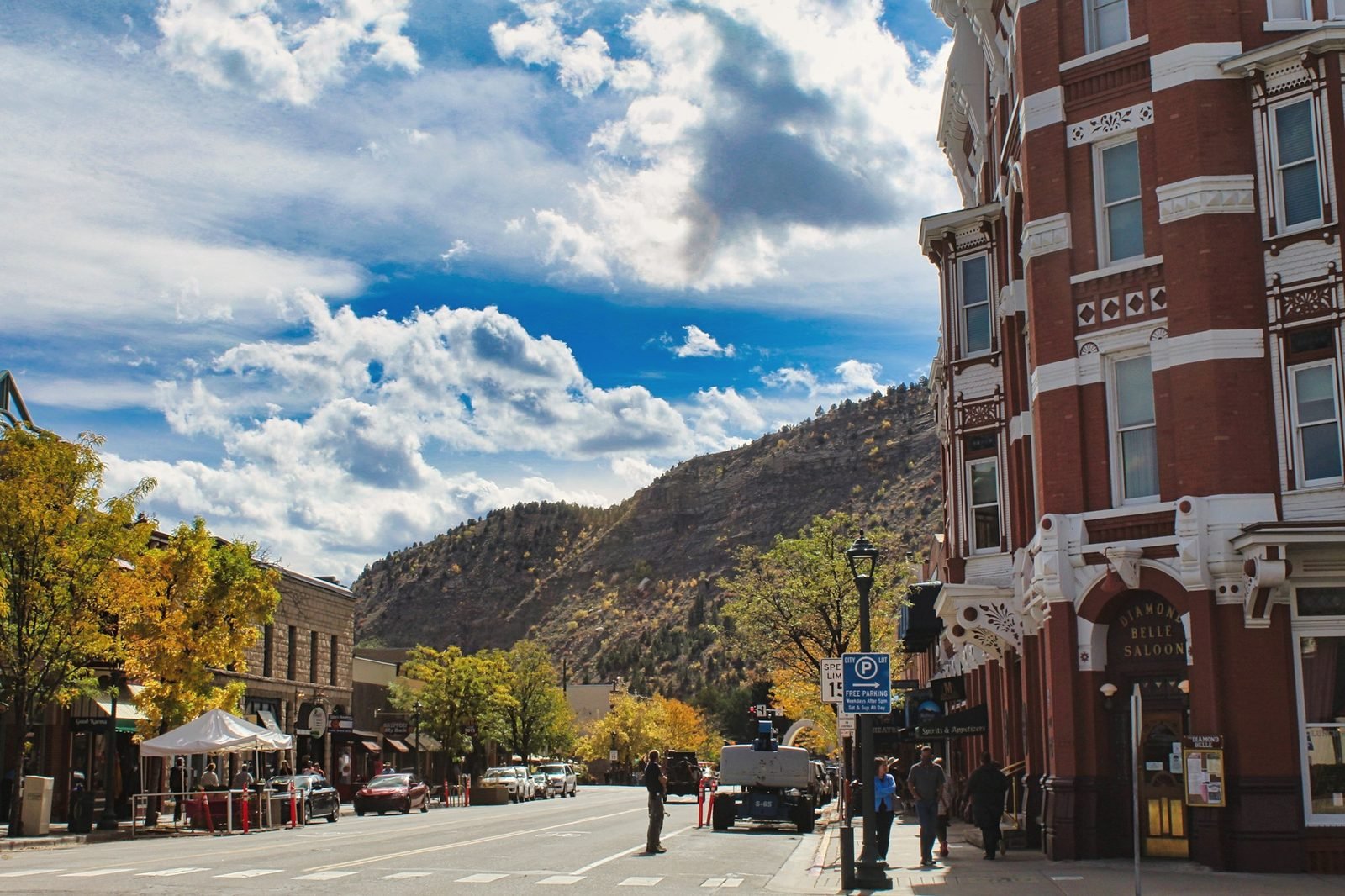 Main Avenue in downtown Durango with brick buildings and mountains behind